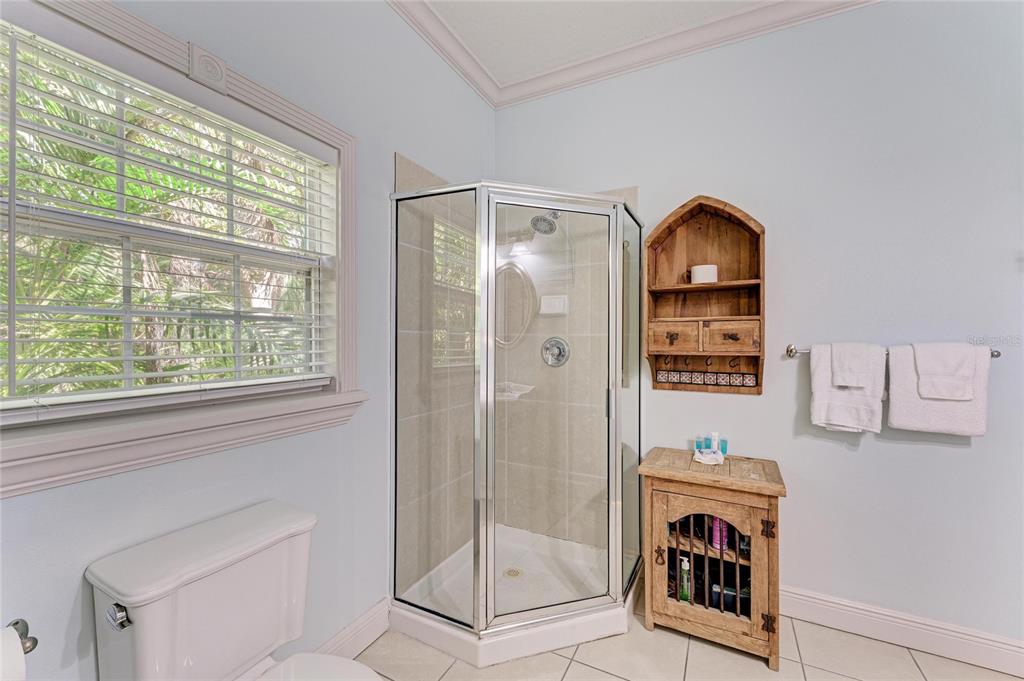 4003 5th Avenue Holmes Beach, FL 34217 - Photo 27 of 56 a bathroom with a shower and mirror