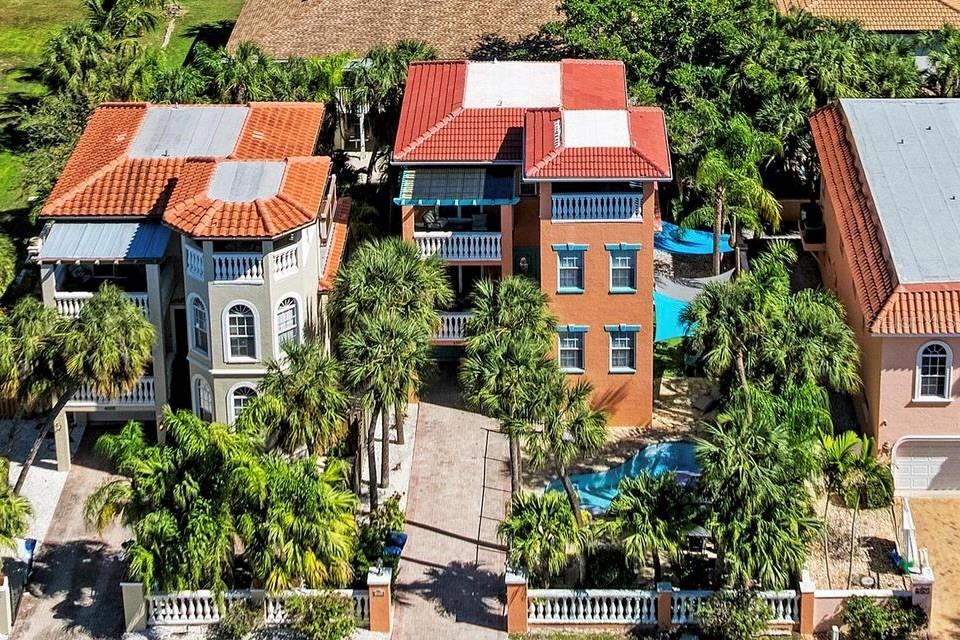 4003 5th Avenue Holmes Beach, FL 34217 - Photo 3 of 56 an aerial view of residential houses with trees