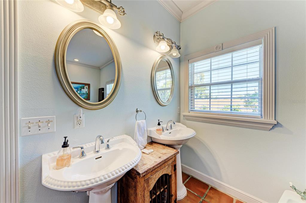 4003 5th Avenue Holmes Beach, FL 34217 - Photo 36 of 56 a bathroom with a sink and a mirror