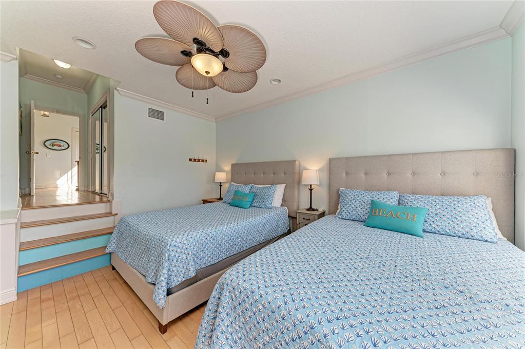 4003 5th Avenue Holmes Beach, FL 34217 - Photo 39 of 56 a bedroom with a bed chandelier and a window