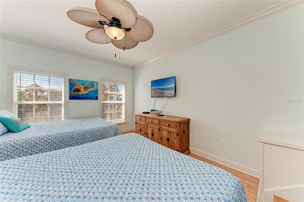 4003 5th Avenue Holmes Beach, FL 34217 - Photo 40 of 56 a bedroom with a bed and a chandelier