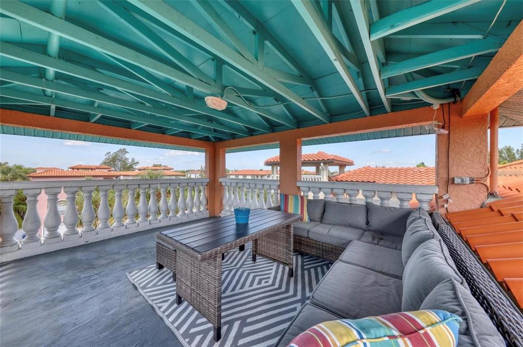 4003 5th Avenue Holmes Beach, FL 34217 - Photo 42 of 56 a balcony with furniture and outdoor seating