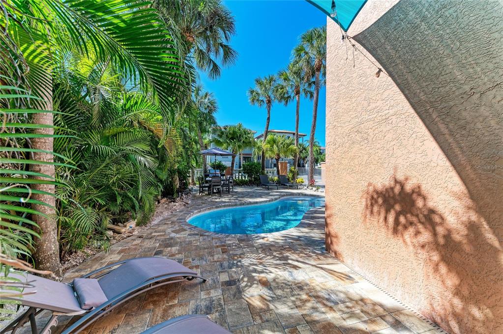 4003 5th Avenue Holmes Beach, FL 34217 - Photo 47 of 56 a view of a backyard with plants and palm tree