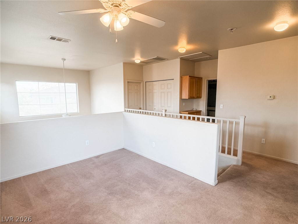 228 Positive Point Street Henderson, NV 89012 - Photo 12 of 27 An airy loft area features neutral carpeting and a ceiling fan for year-round comfort.