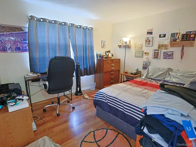 a bed room with a bed and a chair