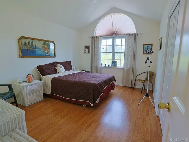 a bedroom with a bed and a large window