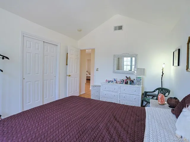 a bedroom with a bed and a dresser