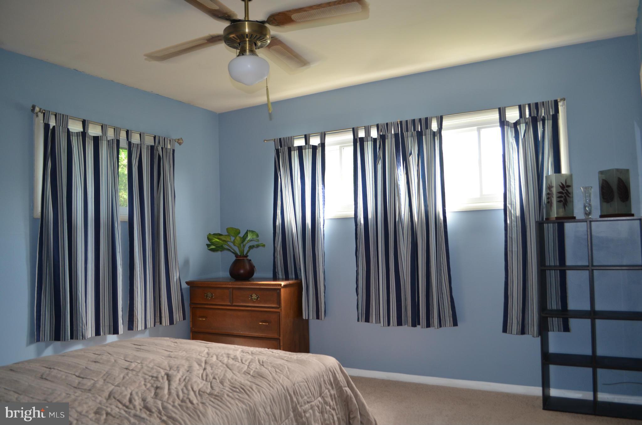 1021 Marksworth Road Baltimore, MD 21228 - Photo 14 of 26 a bedroom with a bed and a chandelier