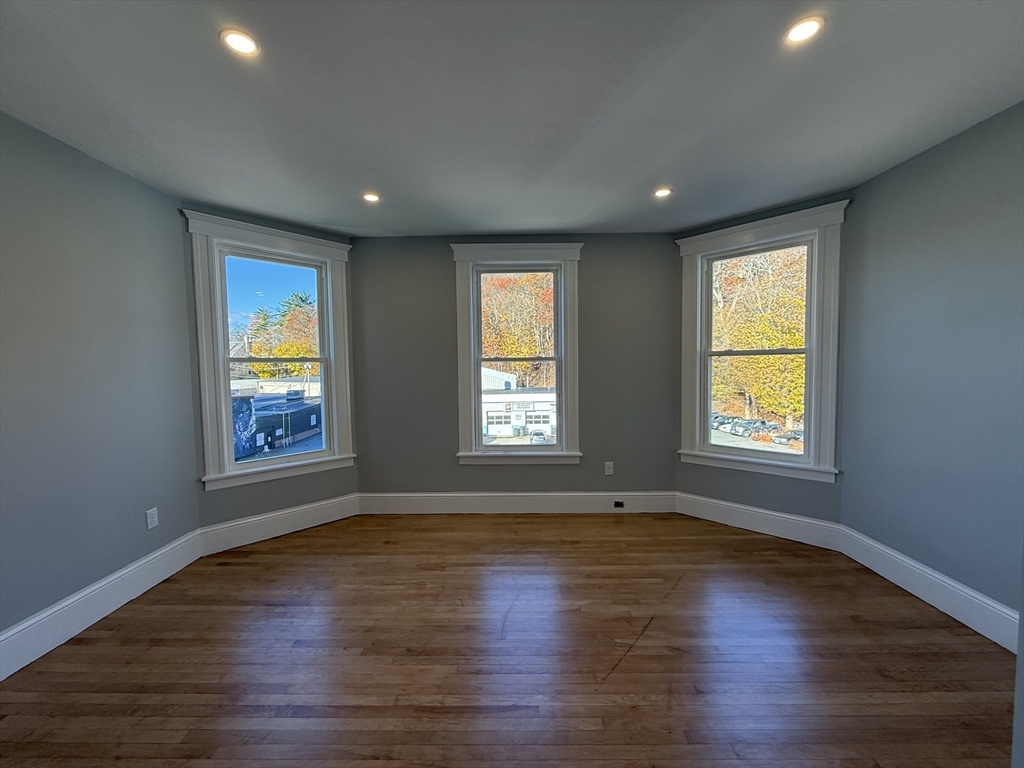 237 Park Avenue, Unit 3 Worcester, MA 01609 - Photo 12 of 20 a view of an empty room with wooden floor and a window