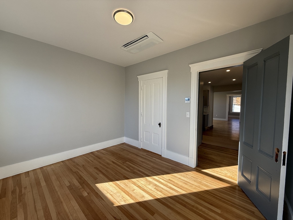 237 Park Avenue, Unit 3 Worcester, MA 01609 - Photo 17 of 20 a bedroom with a bed and wooden floor