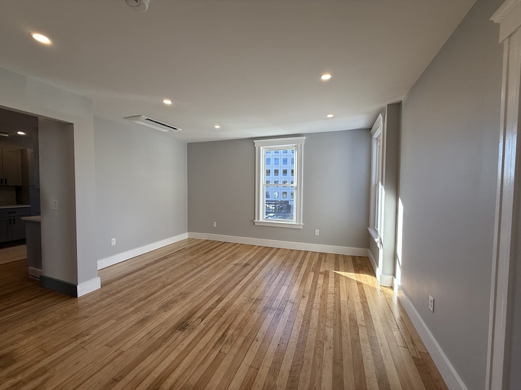 237 Park Avenue, Unit 3 Worcester, MA 01609 - Photo 9 of 20 a view of an empty room with wooden floor and a window