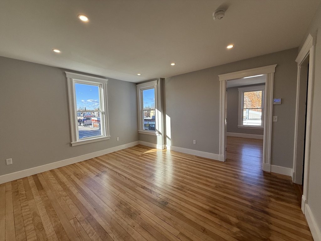 237 Park Avenue, Unit 3 Worcester, MA 01609 - Photo 10 of 20 an empty room with wooden floor and windows