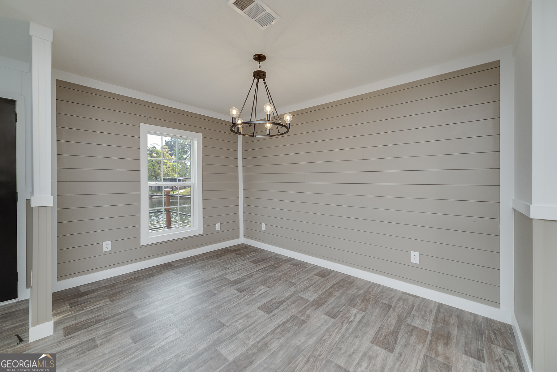 595 Barnetts Bridge Road Jackson, GA 30233 - Photo 16 of 47 a view of empty room with wooden floor and fan