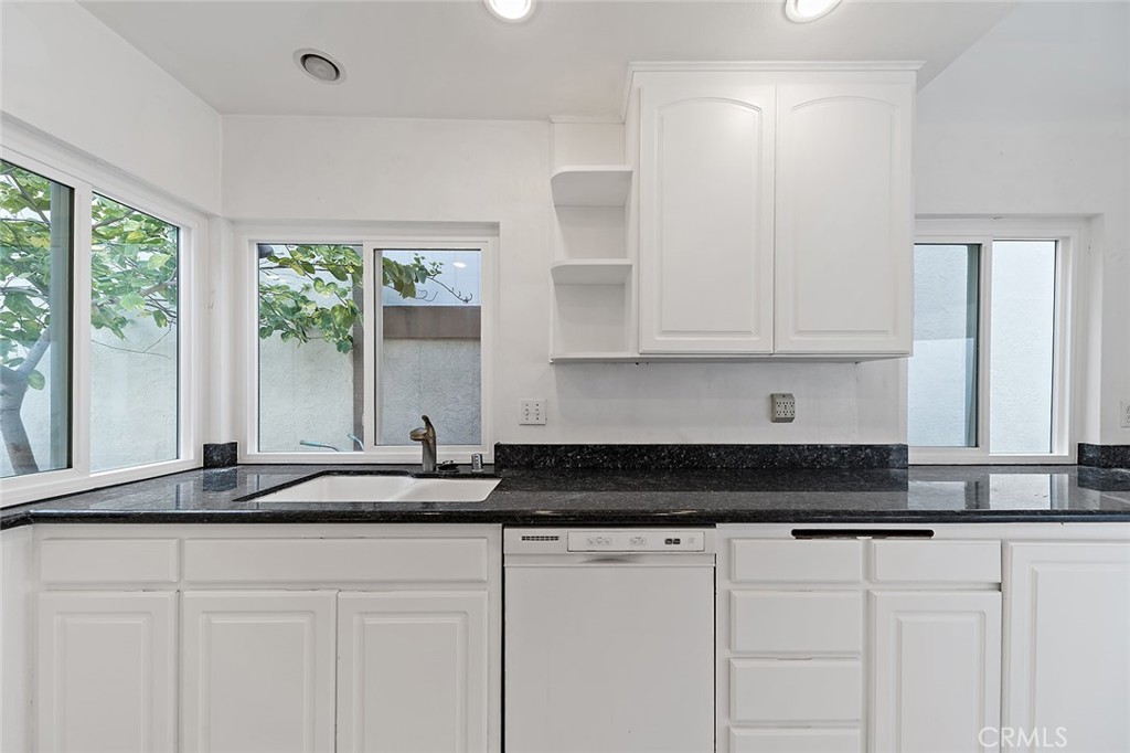 75 Willow Tree Lane Irvine, CA 92612 - Photo 5 of 49 a kitchen with stainless steel appliances granite countertop white cabinets and a granite counter tops
