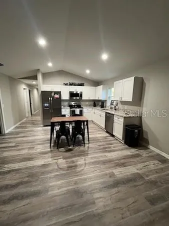 a kitchen with lots of counter top space and appliances