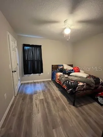 a bedroom with a bed and window