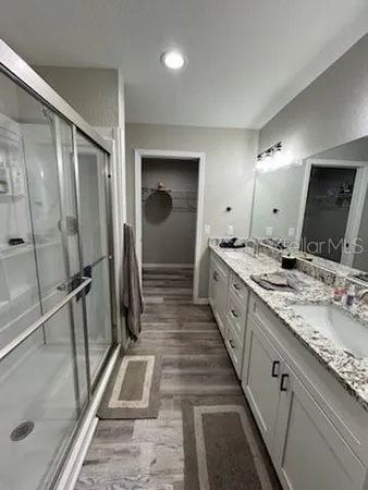 a large bathroom with a double vanity sink and mirror