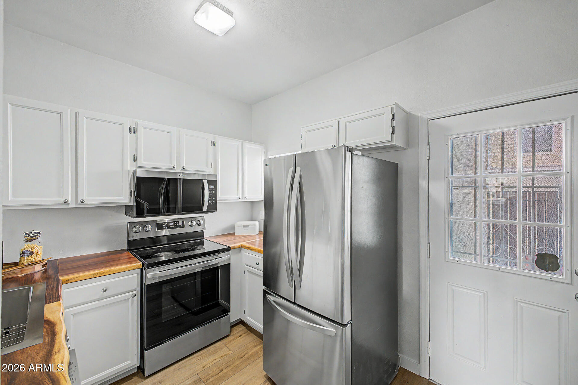 1601 North Saba Street, Unit 301 Chandler, AZ 85225 - Photo 12 of 35 a kitchen with stainless steel appliances a refrigerator a stove a microwave and cabinets