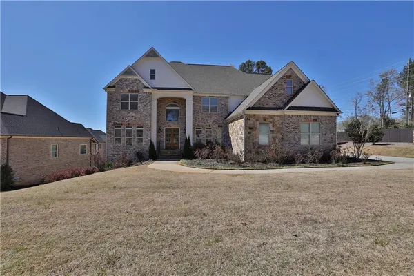 a front view of a house with a yard