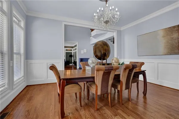 a view of a dining room with furniture and wooden floor