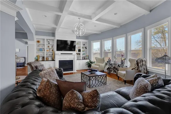 a living room with furniture a fireplace and a flat screen tv