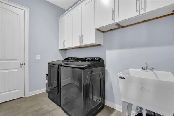 a utility room with sink dryer and washer