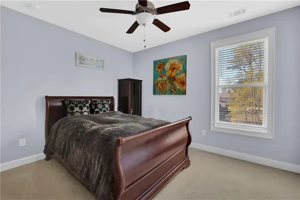 a bed sitting in a bedroom next to a window