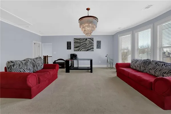 a bedroom with a bed a dresser and next to a window