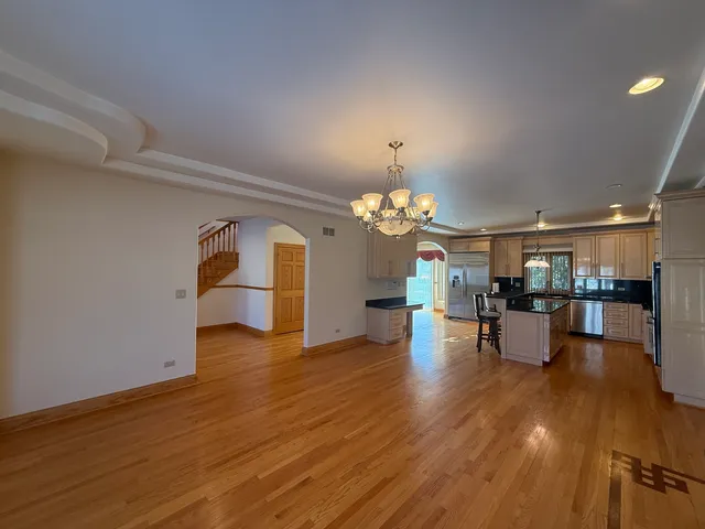 a view of a dining room with furniture wooden floor and chandelier