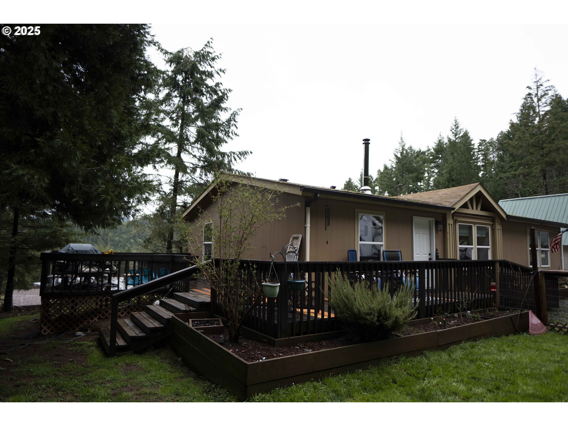6228 Upper Cow Creek Road Azalea, OR 97410 - Photo 1 of 47 a view of a house with wooden deck and furniture