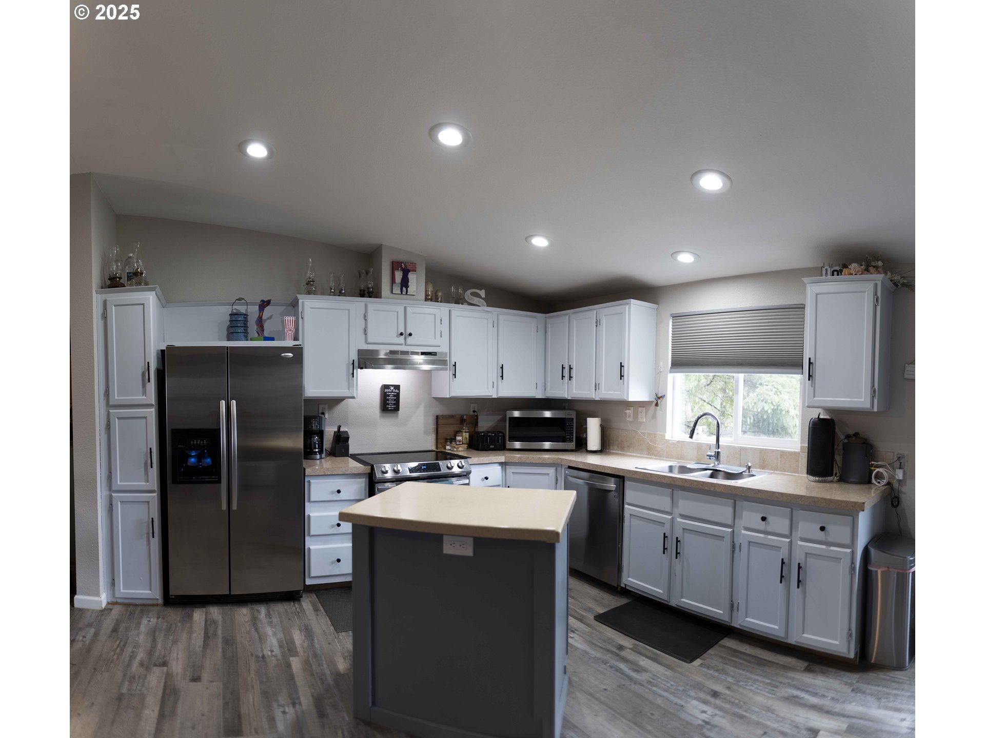 6228 Upper Cow Creek Road Azalea, OR 97410 - Photo 15 of 47 a kitchen with a sink a refrigerator and cabinets