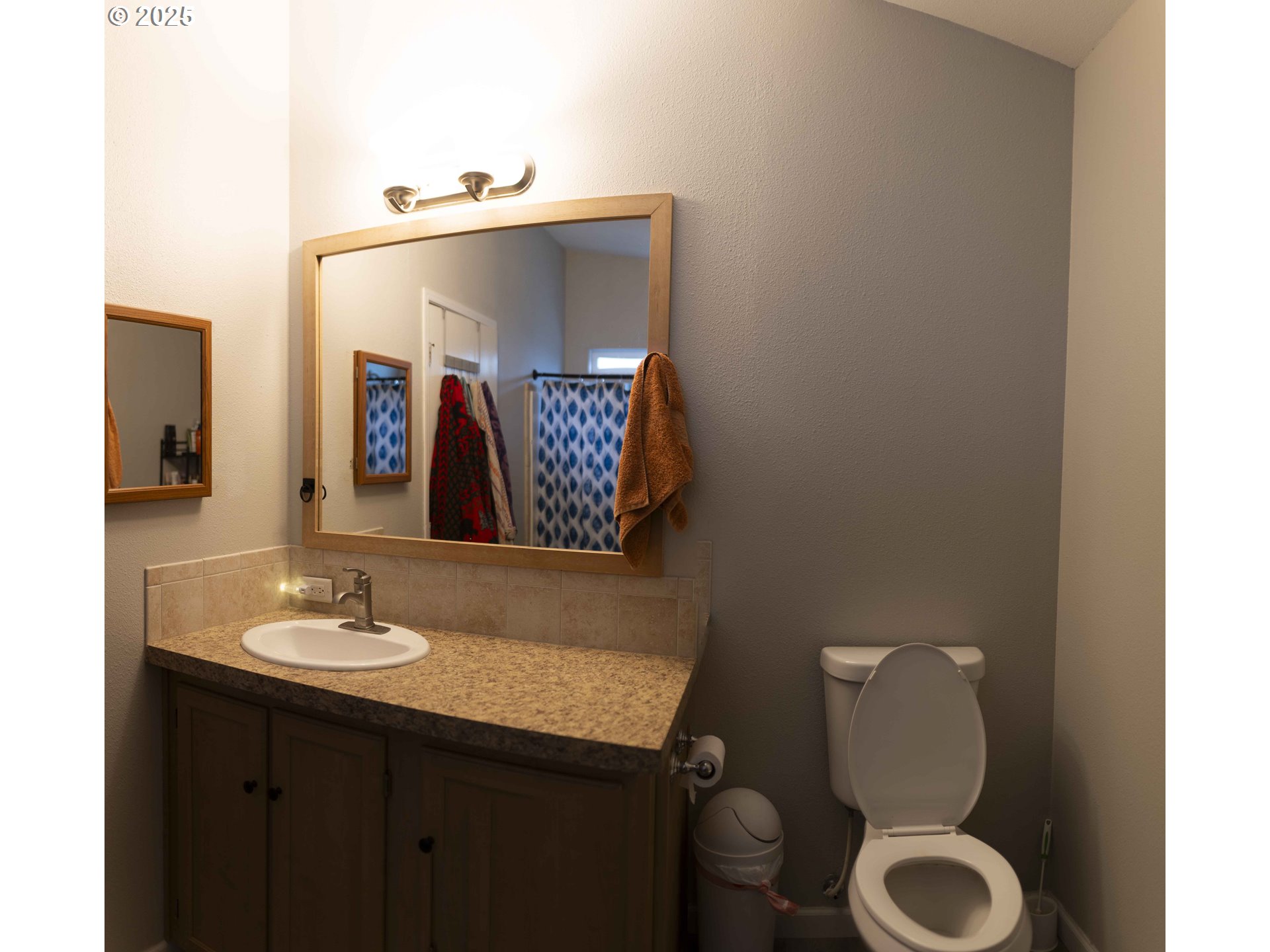 6228 Upper Cow Creek Road Azalea, OR 97410 - Photo 20 of 47 a bathroom with a toilet sink and mirror