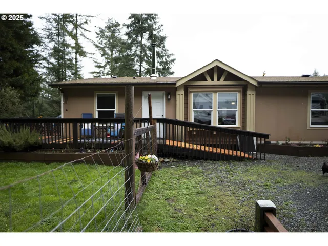 a view of a house with a yard and a deck
