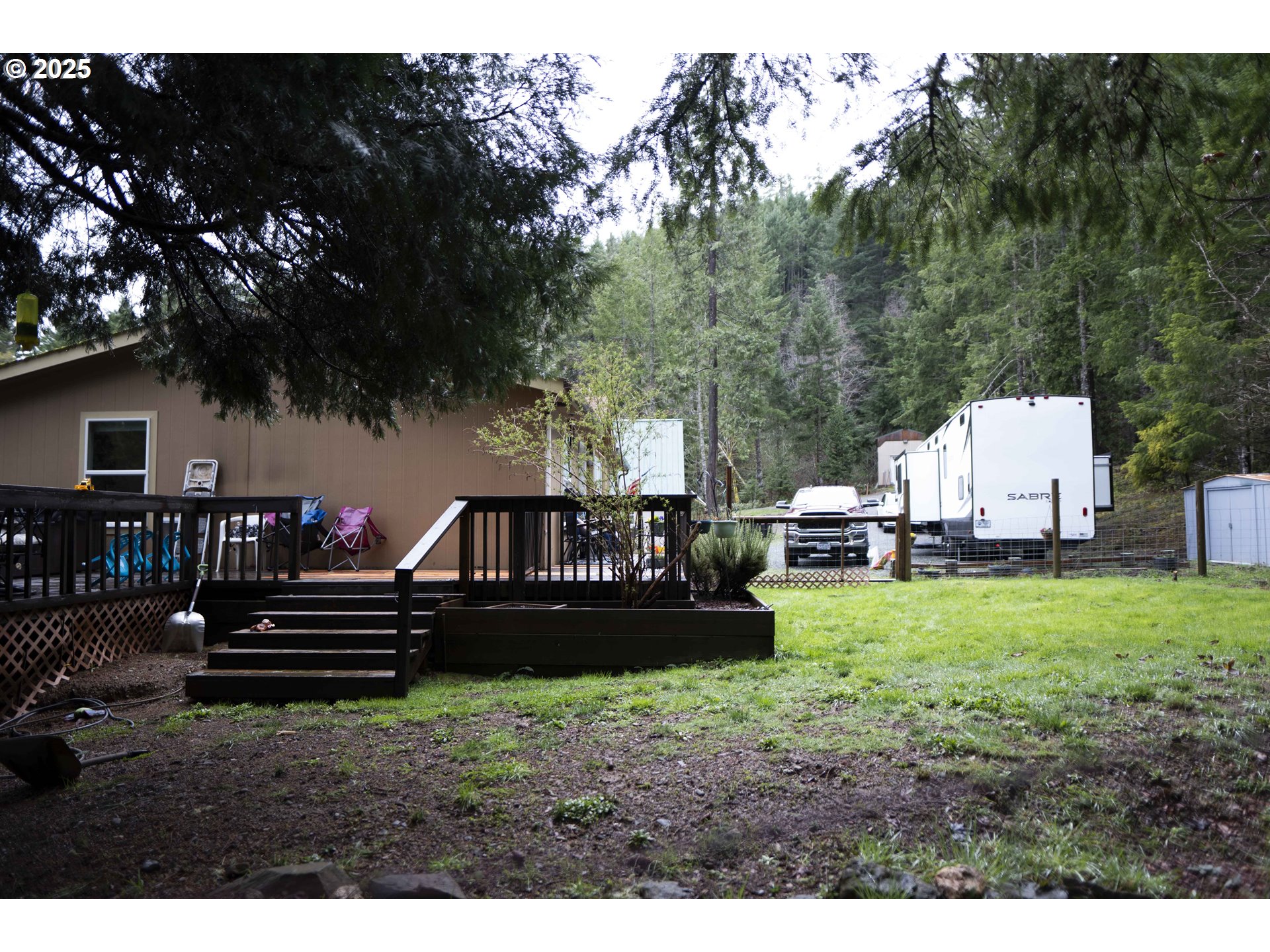 6228 Upper Cow Creek Road Azalea, OR 97410 - Photo 10 of 47 a view of house with backyard and a garden