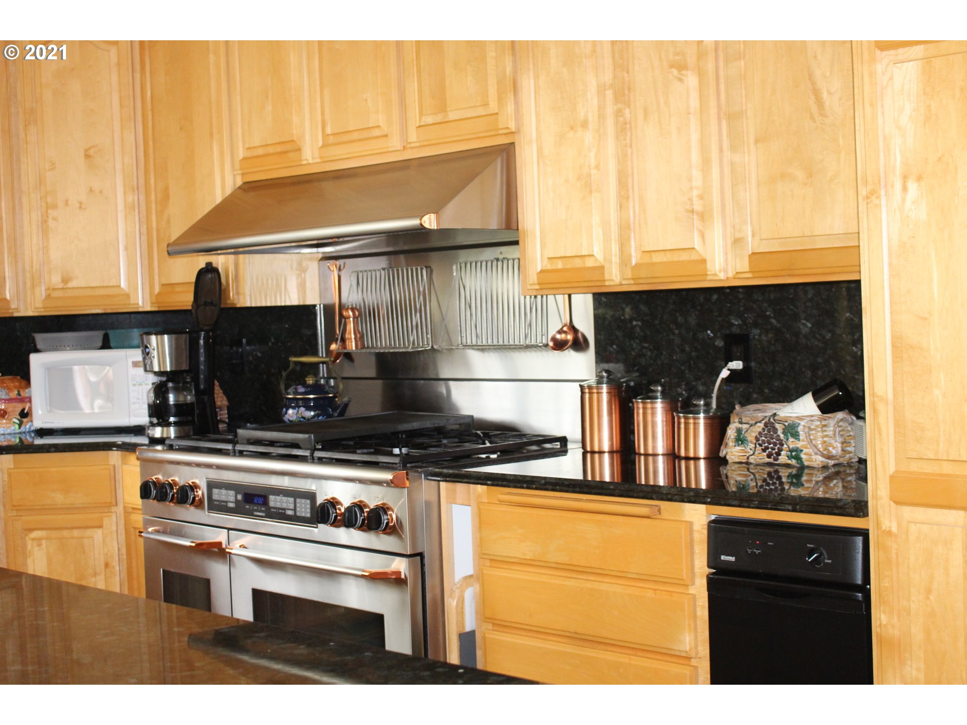 22711 Northwest 67th Avenue Ridgefield, WA 98642 - Photo 3 of 19 a kitchen with a stove and a microwave