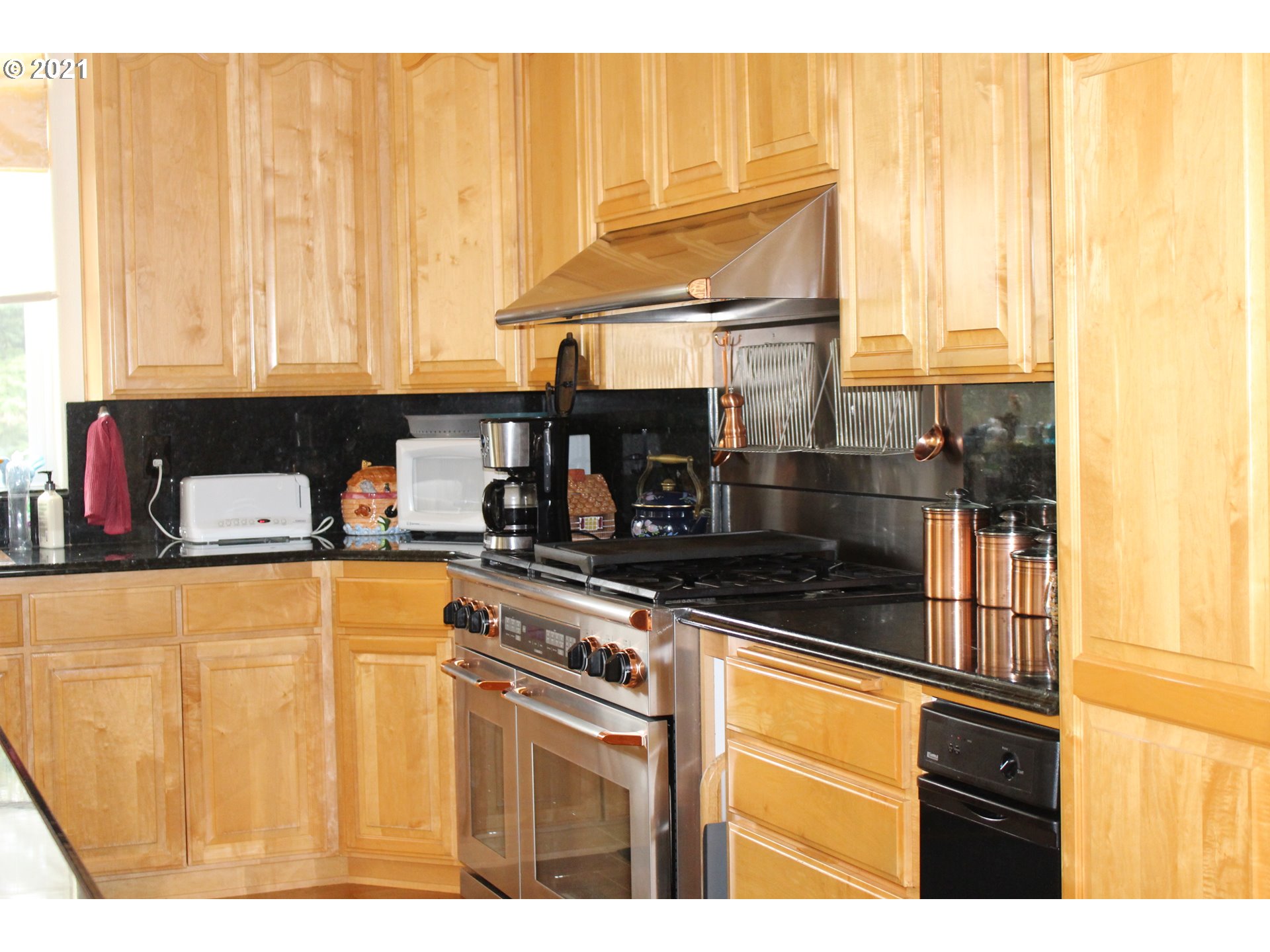 22711 Northwest 67th Avenue Ridgefield, WA 98642 - Photo 4 of 19 a kitchen with stainless steel appliances granite countertop a sink and cabinets