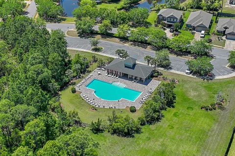 an aerial view of a house with a garden and swimming pool