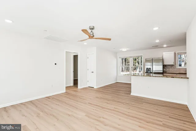 a view of a kitchen with wooden floor and a sink