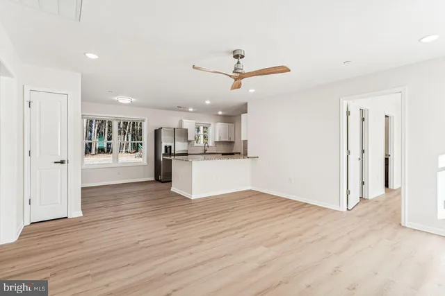 a view of a kitchen with wooden floor and a kitchen