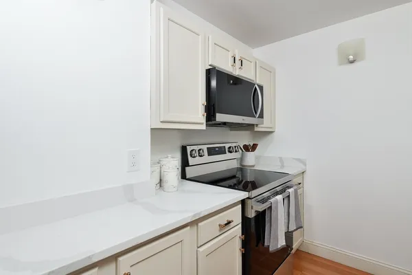 a kitchen with a sink and a stove top oven