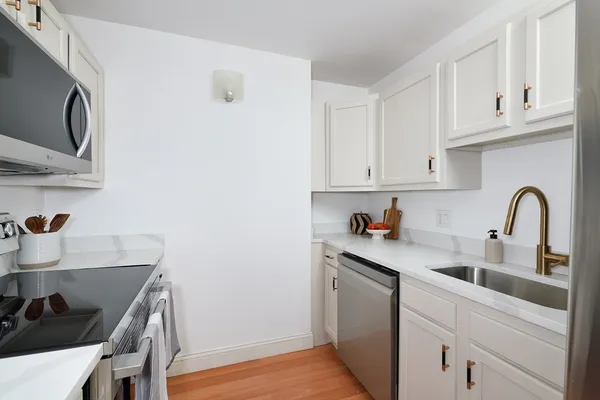 a kitchen with stainless steel appliances granite countertop a sink and cabinets