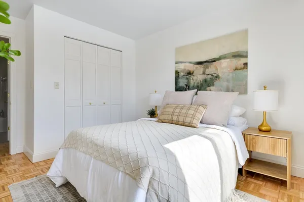 a bedroom with a bed and a window