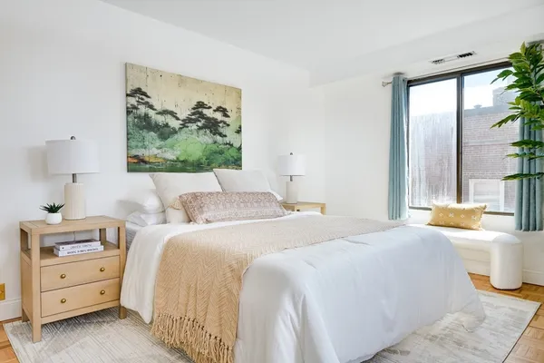 a bedroom with a bed and a painting on the wall