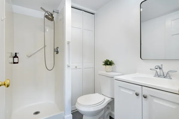 a bathroom with a sink a toilet and shower