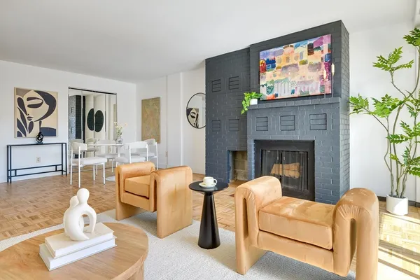 a living room with furniture a flat screen tv and a fireplace
