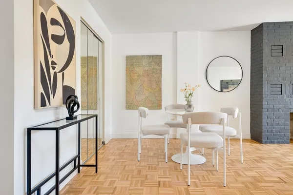 a dining room with furniture and a mirror