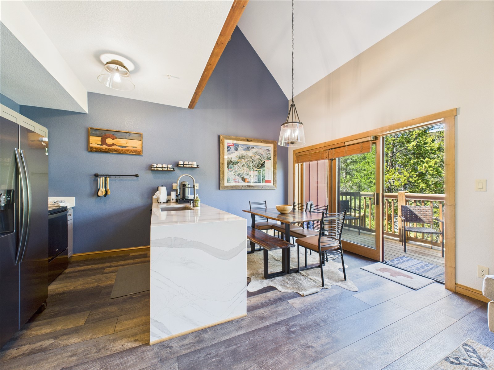 27 Lake Ridge Circle, Unit 1842 Keystone, CO 80435 - Photo 12 of 50 Open-concept space with quartz island, vaulted ceilings, and sliding doors to a deck with mountain air and views.