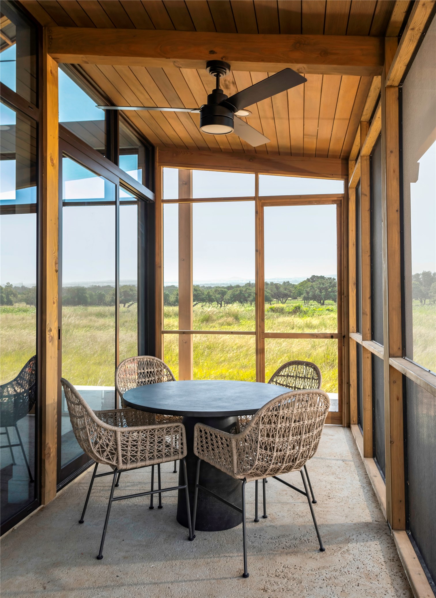 312 Hye Springs Road, Unit 106 Hye, TX 78635 - Photo 8 of 17 Screened outdoor living space offers a peaceful setting for dining and relaxing while overlooking the surrounding Hill Country landscape.