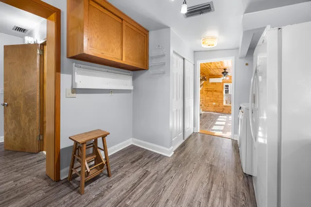 a view of a workspace with furniture and wooden floor