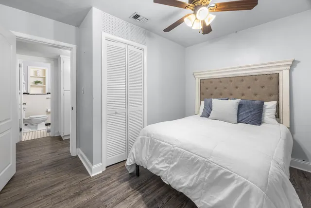 a bathroom with a sink a toilet a mirror and shower